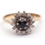 Sapphire and diamond cluster ring, the circular-shaped sapphire claw set and raised within a