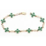 Modern emerald and diamond articulated bracelet, having flower cluster links, joined by curved bar