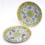 Pair of Chinese porcelain plates decorated in famille rose enamels, with courtiers, dogs and