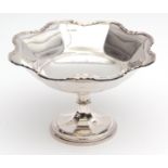 George V footed bowl of faceted form with applied rim and polished field on a knopped stem and