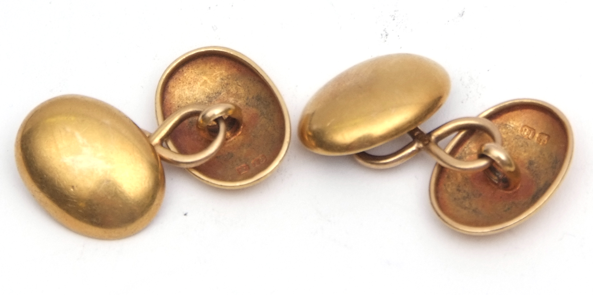 Pair of 18ct gold cuff links, oval shaped, plain polished design with chain connectors, hallmarked