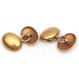 Pair of 18ct gold cuff links, oval shaped, plain polished design with chain connectors, hallmarked