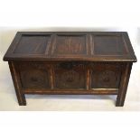 17th century oak three-panelled coffer with carved floral panels and inlaid detail, fitted with