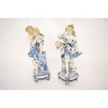 Pair of late 19th century KPM porcelain figures of maidens with cherubs, 40cms high