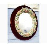 Late 19th century mirror with Continental porcelain floral encrusted frame, the mirror 34cms diam