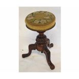 Victorian walnut adjustable piano stool with embroidered floral top on a carved column and supported
