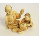 Small Japanese ivory okimono of a mask carver and his son