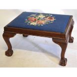 Late 19th century mahogany square formed foot stool with blue floral embroidered top raised on
