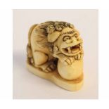 Japanese ivory netsuke modelled as a ShiShi with a ball