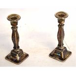 Pair of repaired silver candlesticks on square bases and columns, with loaded bases, each 16cms tall