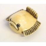 Japanese ivory netsuke carved as a stylised sparrow, signed to base