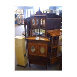 Edwardian walnut corner cupboard, the top fitted with two open shelves with mirrored back, the