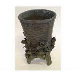 Unusual bronze basket formed vase with flower encrusted detail, raised on three feet, 18cms tall