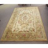 Chinese thick pile wool carpet with a cream ground, central floral lozenge and border, 155cms wide x