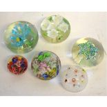 Mixed Lot: six assorted paperweights to include one with four lilies, a multi-twisted cane