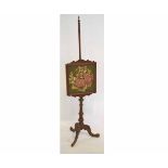 Victorian mahogany pole screen with embroidered panel of flowers on a turned column and a carved