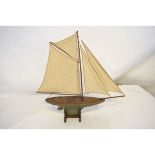 Late 19th/early 20th century pond yacht and stand with a painted hull and fitted with four