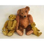 Three vintage teddy bears of varying sizes with stitched features and glass eyes, tallest 145cms
