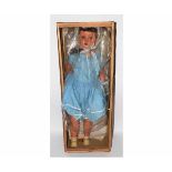 Good quality large composition doll in a blue dress with brown glass eyes and painted features,