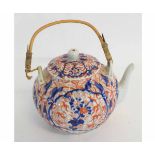 20th century Imari decorated teapot with wicker handle