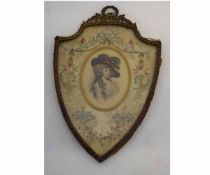 Victorian coloured print in shield shape frame with stitch work mount