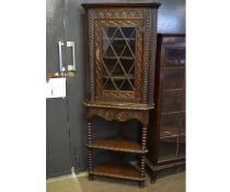 Victorian Gothic oak carved floor standing corner cupboard, the top fitted with single astragal
