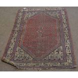 Good quality red and cream ground floor rug with a geometric border and central rust diamond
