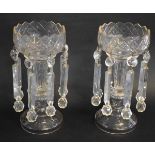 Pair of clear cut glass lustres with castellated top, with prismatic drops, each 30cms tall