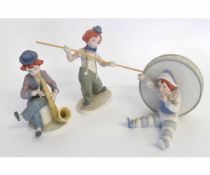 Group of three Goebel figures, one of a young boy sitting beside a drum H404, a further boy