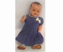 Composition doll with glass eyes and painted features in a decorative blue dress with embroidery (