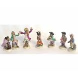 Collection of seven Continental monkey band figures including a conductor and musicians, the