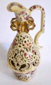 Late 19th century reticulated ewer decorated in typical fashion by Fisher of Budapest, 37cms high