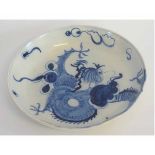 Unusual blue and white dish, with a dragon chasing the flaming pearl, 20cms diam