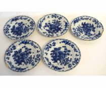 Set of five 18th century Dutch Delft blue and white plates with floral decorated borders and centres