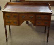 Georgian mahogany five drawer desk with galleried back with brass swing handles, raised on four ring