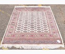 Modern Bokhara floor rug with cream ground and repeating lozenge centre and multi-gulled border, 190