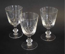 Set of three faceted cut wine glasses with knopped stem and circular foot, 15cms tall