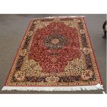 Modern Keshan carpet with a rust and cream ground with floral details and a blue border, 160cms wide