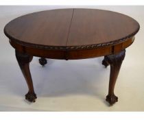 Late 19th/early 20th century oval mahogany extending dining table with carved edge, supported on