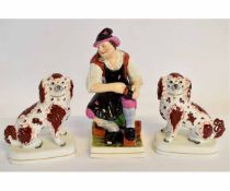 Pair of English Staffordshire dogs in seated pose with raised front legs, hollow bases, 22cms