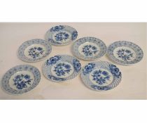 Set of seven Meissen plates decorated with the onion pattern within reticulated floral borders,