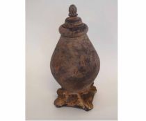 Decorative terracotta urn formed lidded vase on a shaped square base, 38cms tall