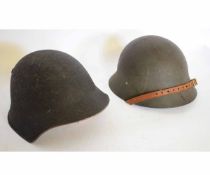 Two grey finished steel helmets including Swedish M26 and Swiss M18 examples, each with stitched
