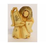 Unusual Japanese ivory netsuke of a long-haired figure holding a vase and having a revolving head