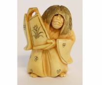 Unusual Japanese ivory netsuke of a long-haired figure holding a vase and having a revolving head