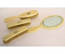 Four items of Victorian ivory backed dressing table wares, viz hand mirror, hair brush and two