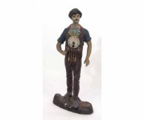 Painted base metal novelty timepiece modelled in the form of a clock seller wearing a green hat