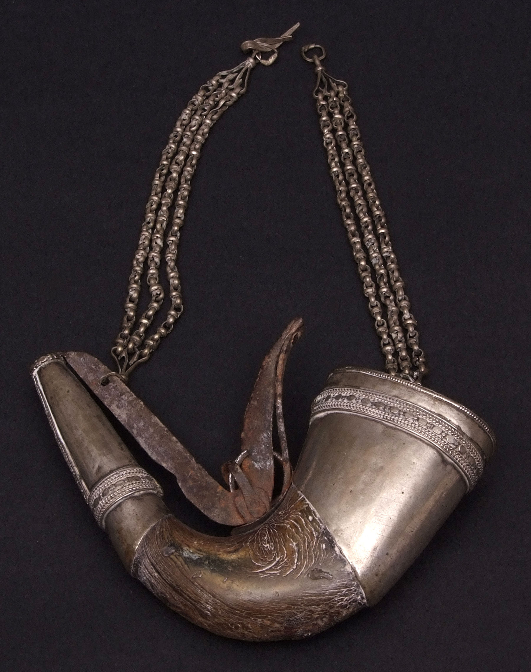 Middle Eastern metal mounted and horn shot/powder flask of curved form with pull off cover and