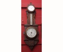 Early 20th century oak cased combination timepiece/aneroid barometer, the case with carved foliate