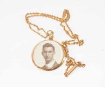 Gold plated pendant and neckchain, the circular pendant glazed both sides and bearing a head and
